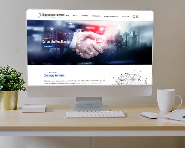 The Strategic Partners website on a computer monitor